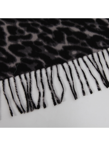 Close-up of the black and gray leopard-print scarf edge with twisted fringe