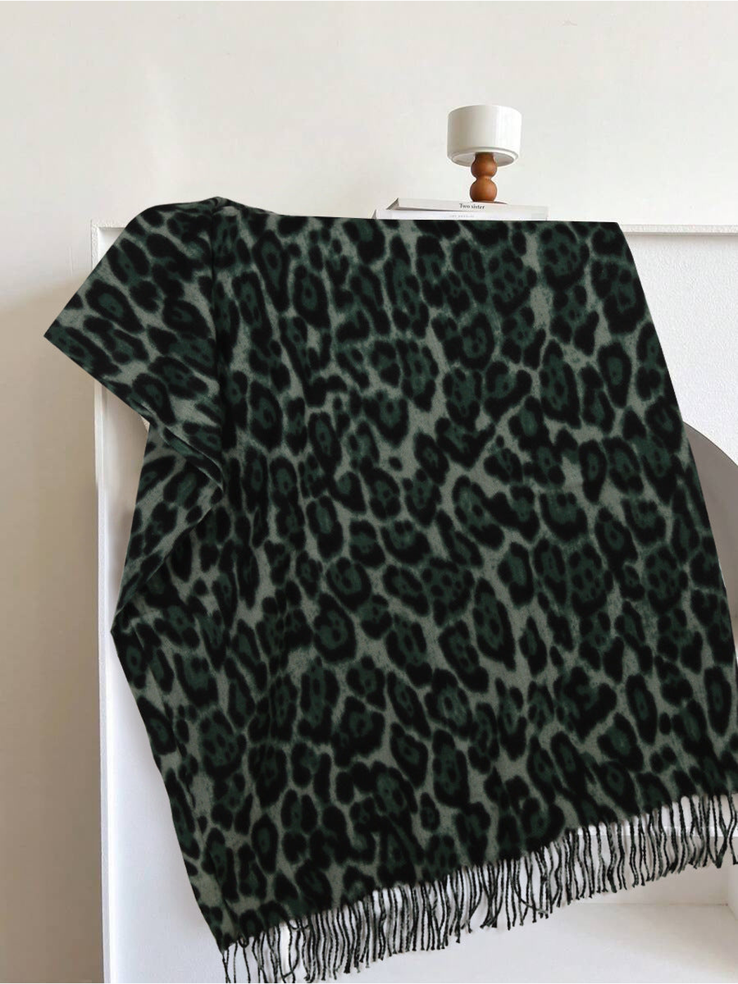 Dark green leopard-print rectangular scarf with fringed edges, full view