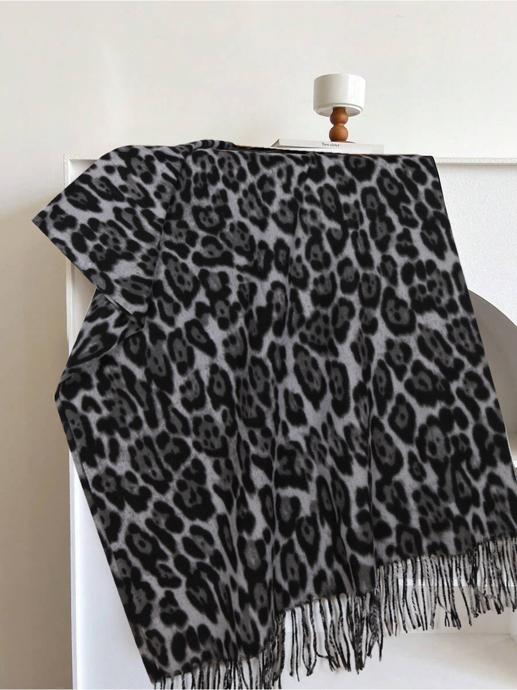 Black and gray leopard-print rectangular scarf with fringed edges, full view
