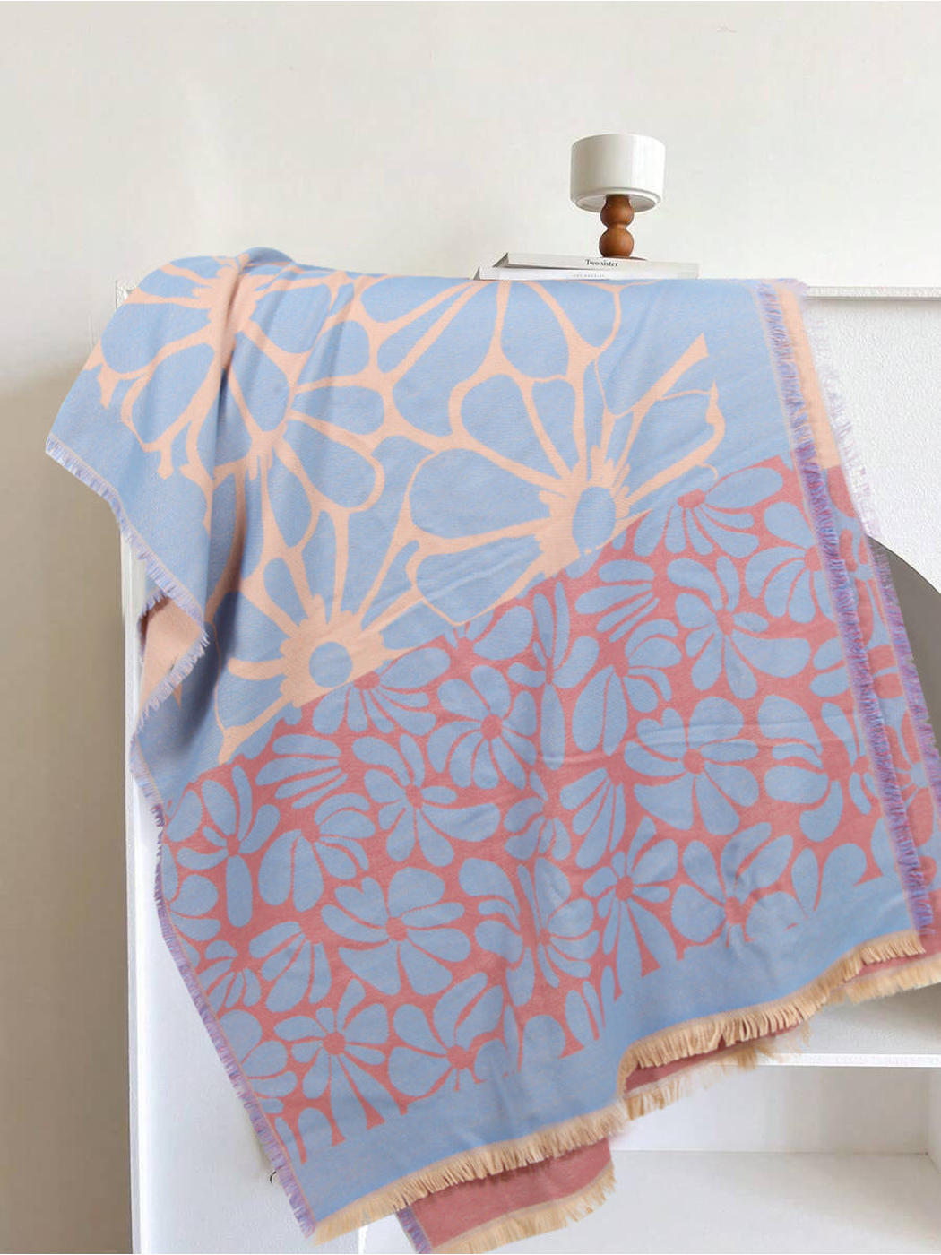 Light blue, peach and coral floral scarf draped to show its contrasting panels and fringe