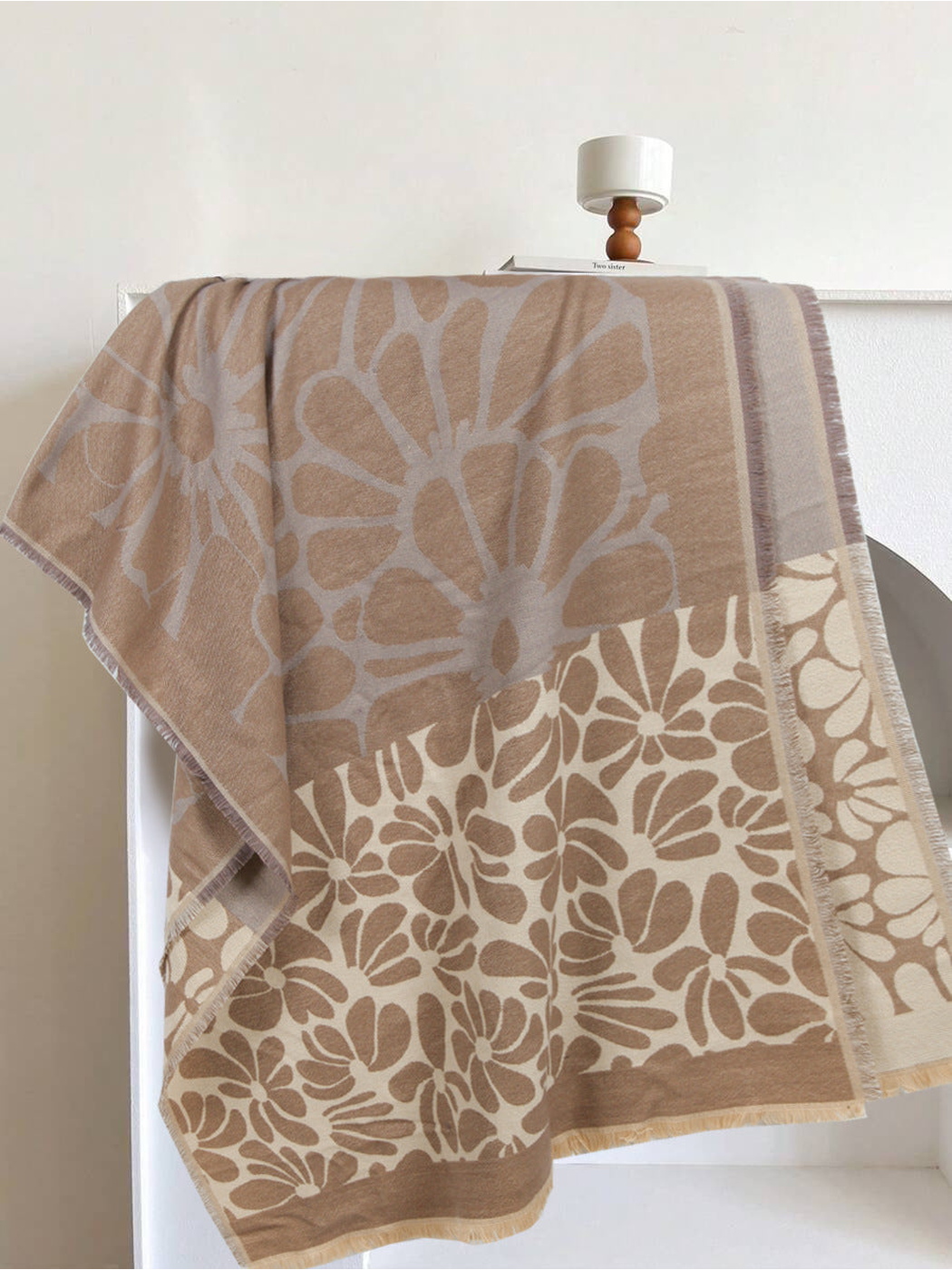 Khaki and cream floral scarf draped to show its contrasting flower panels and fringe