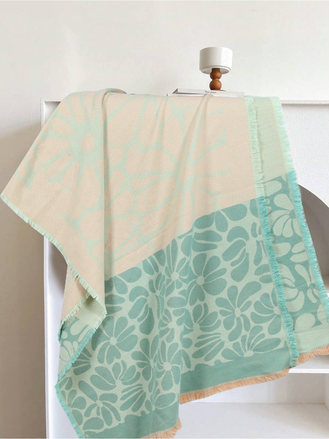 Mint green and cream floral scarf draped to show its contrasting flower panels and fringe