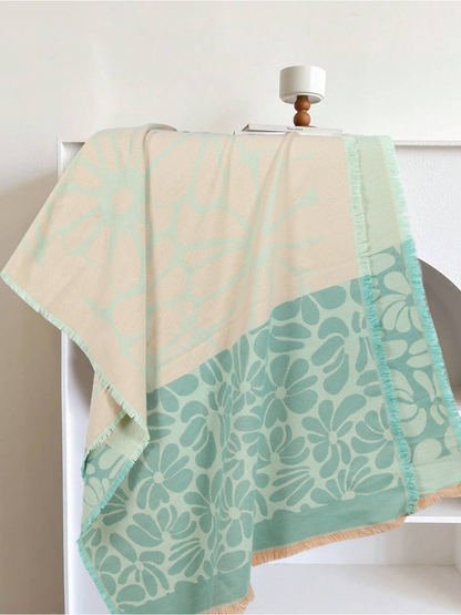 Mint green and cream floral scarf draped to show its contrasting flower panels and fringe