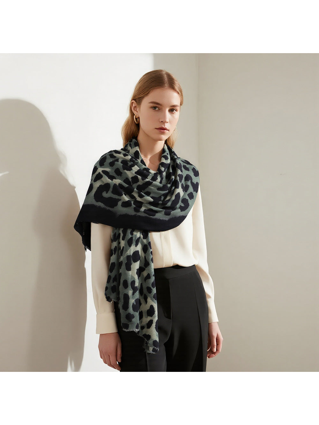 Green and black animal-print scarf wrapped across the shoulders