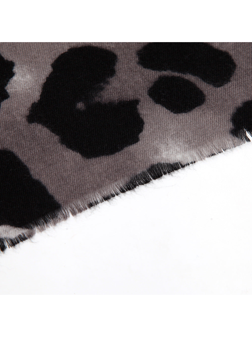 Close-up of the scarf's short fringed edge and spotted print