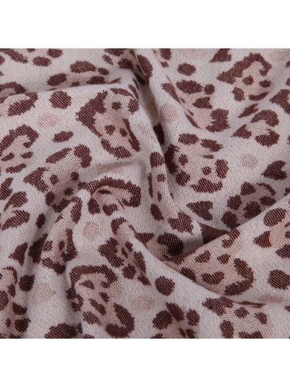 Close-up of the scarf's spotted pattern and fine woven texture