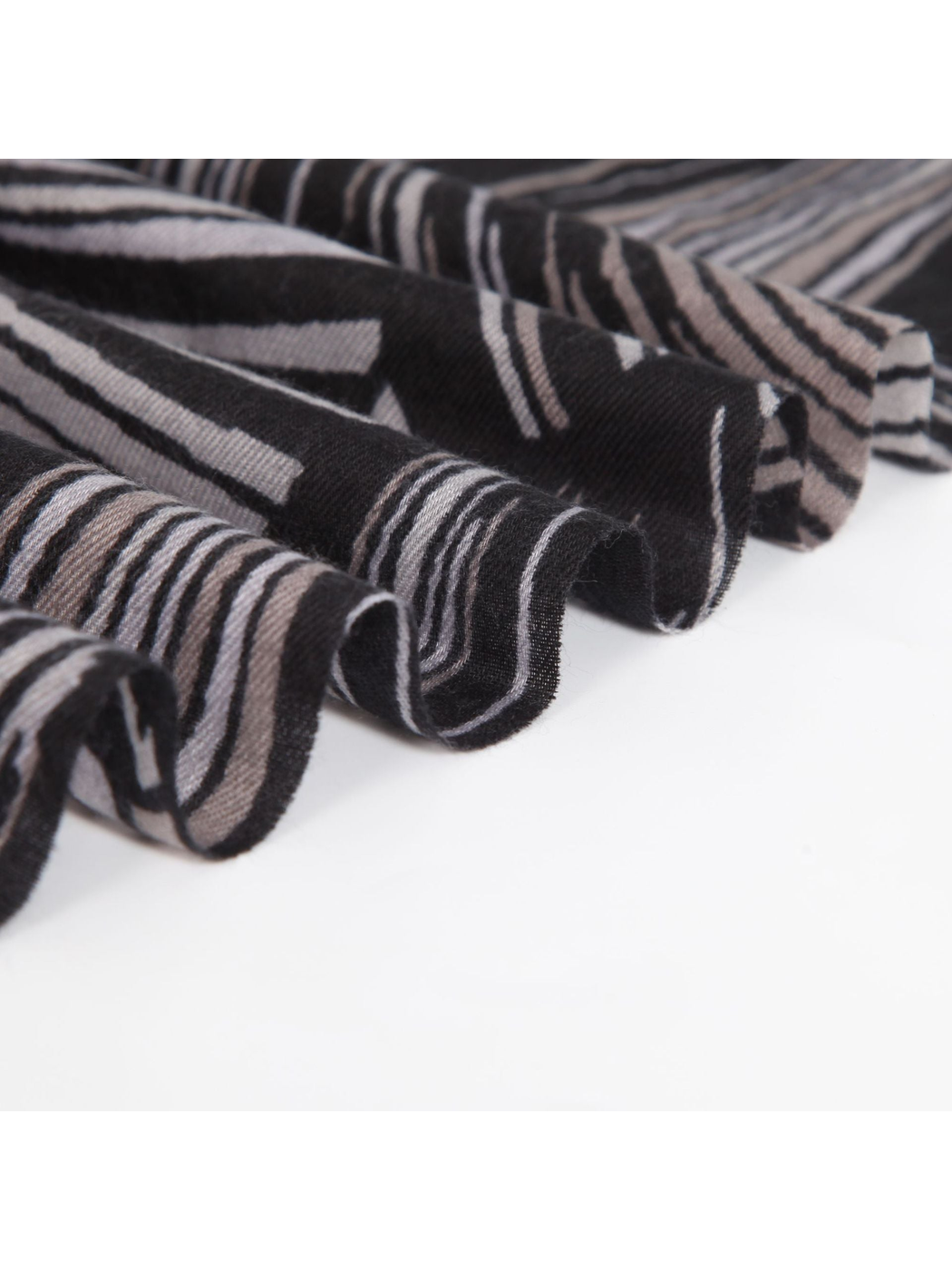 Close-up of the scarf's woven texture and radiating stripe pattern