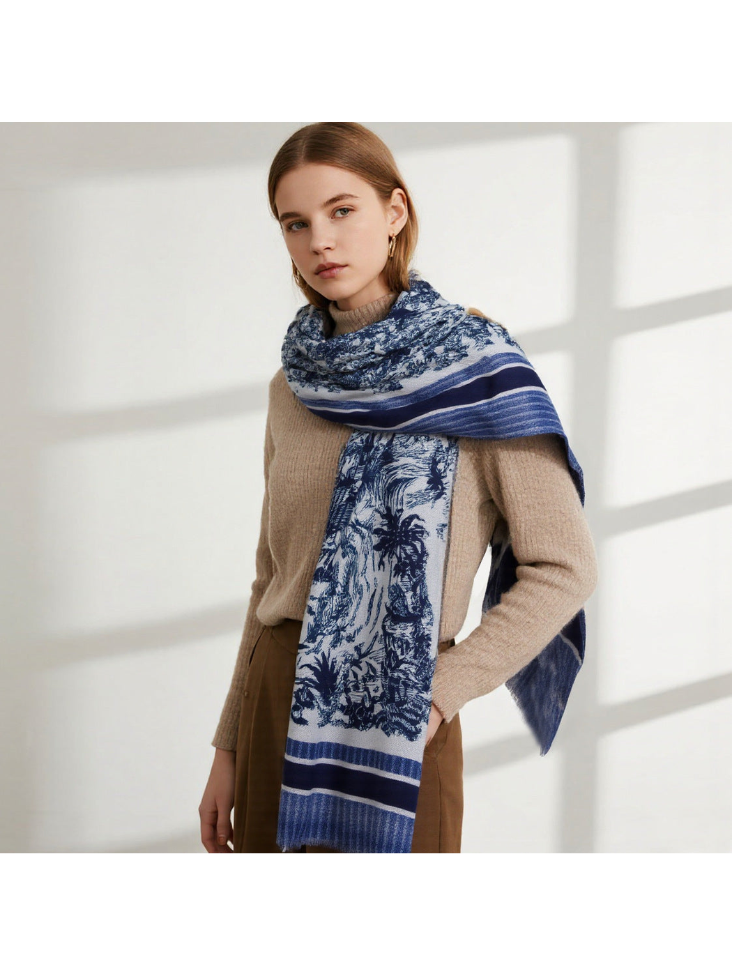 Blue pastoral toile scarf wrapped around the neck with one end draped in front