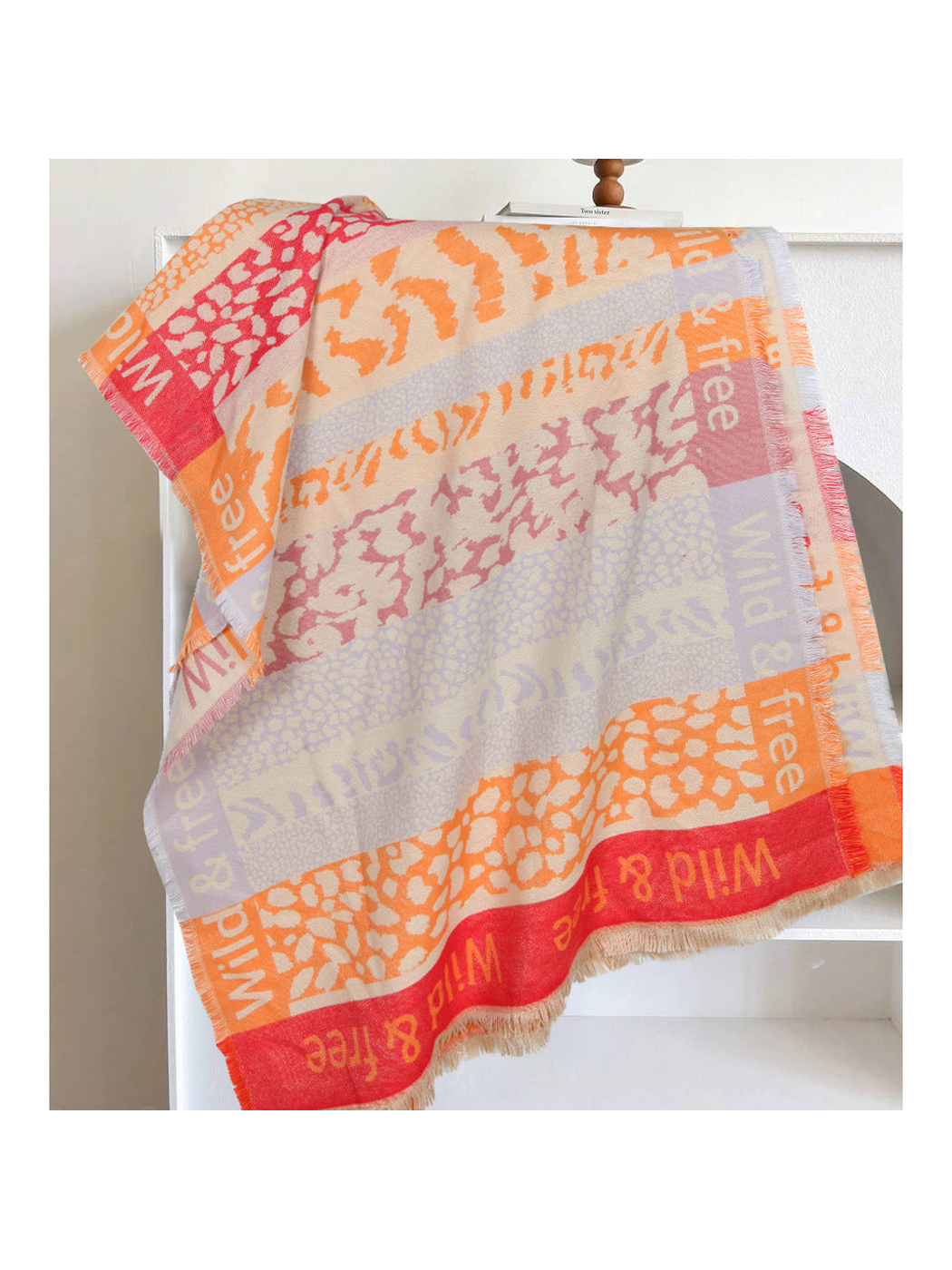 Orange-red patchwork animal-print scarf with woven lettering and fringe