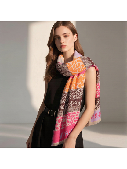 Orange, pink and brown patchwork scarf worn looped around the neck