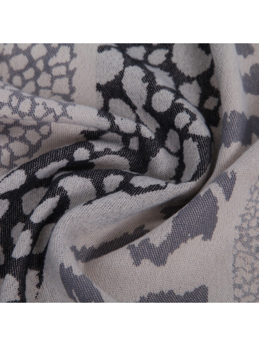 Close-up of the scarf's woven texture and animal-inspired pattern