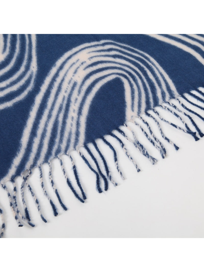 Close-up of the blue scarf's twisted fringe and curved-line motif