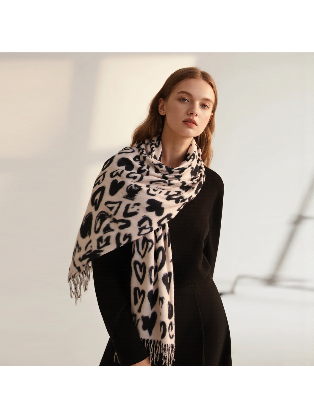 Ivory scarf with black heart pattern styled over one shoulder