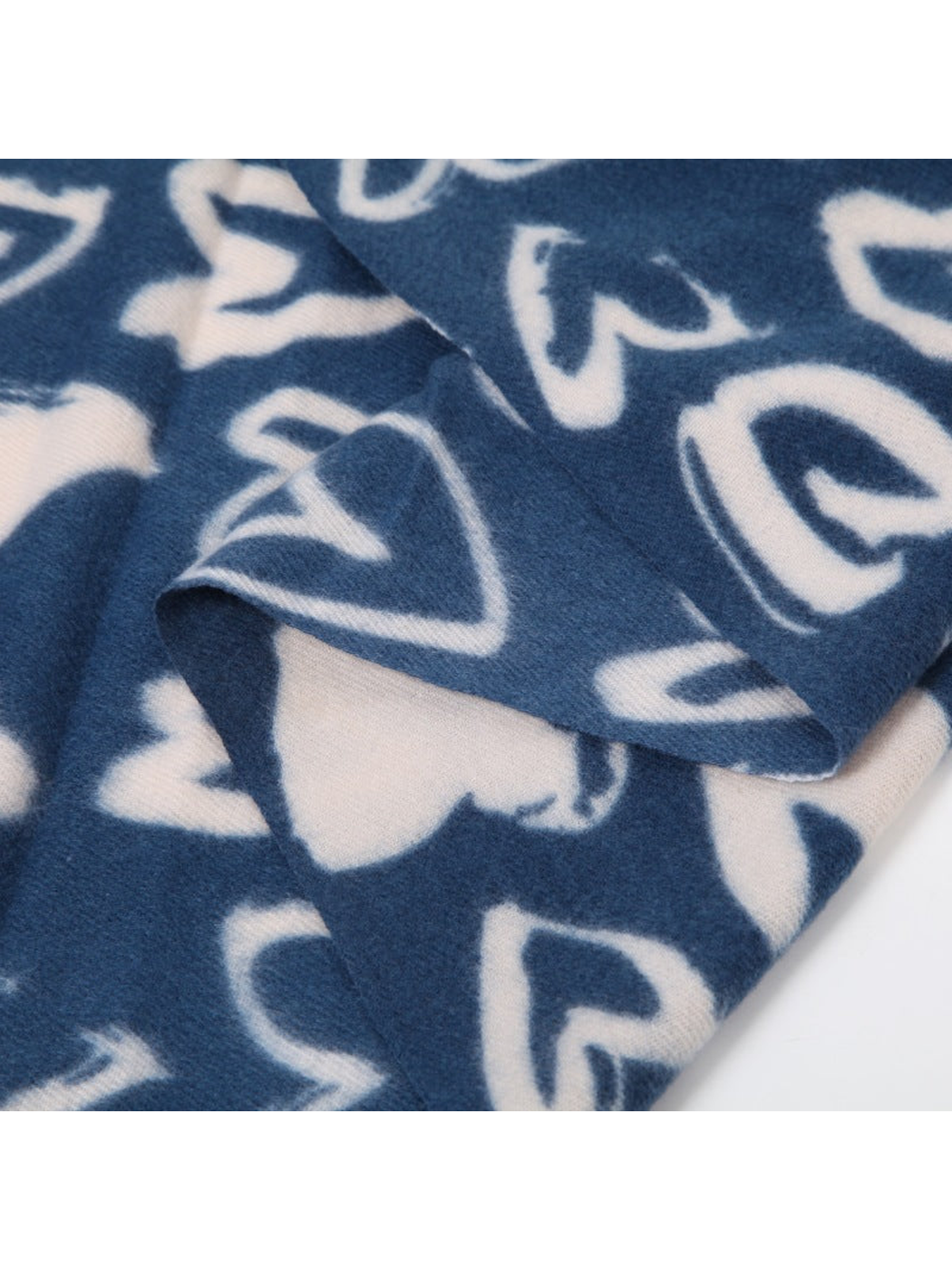 Close-up of the navy and ivory heart pattern and brushed surface