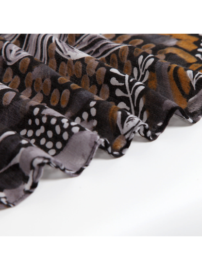 Close-up of the scarf's fine woven texture and abstract print