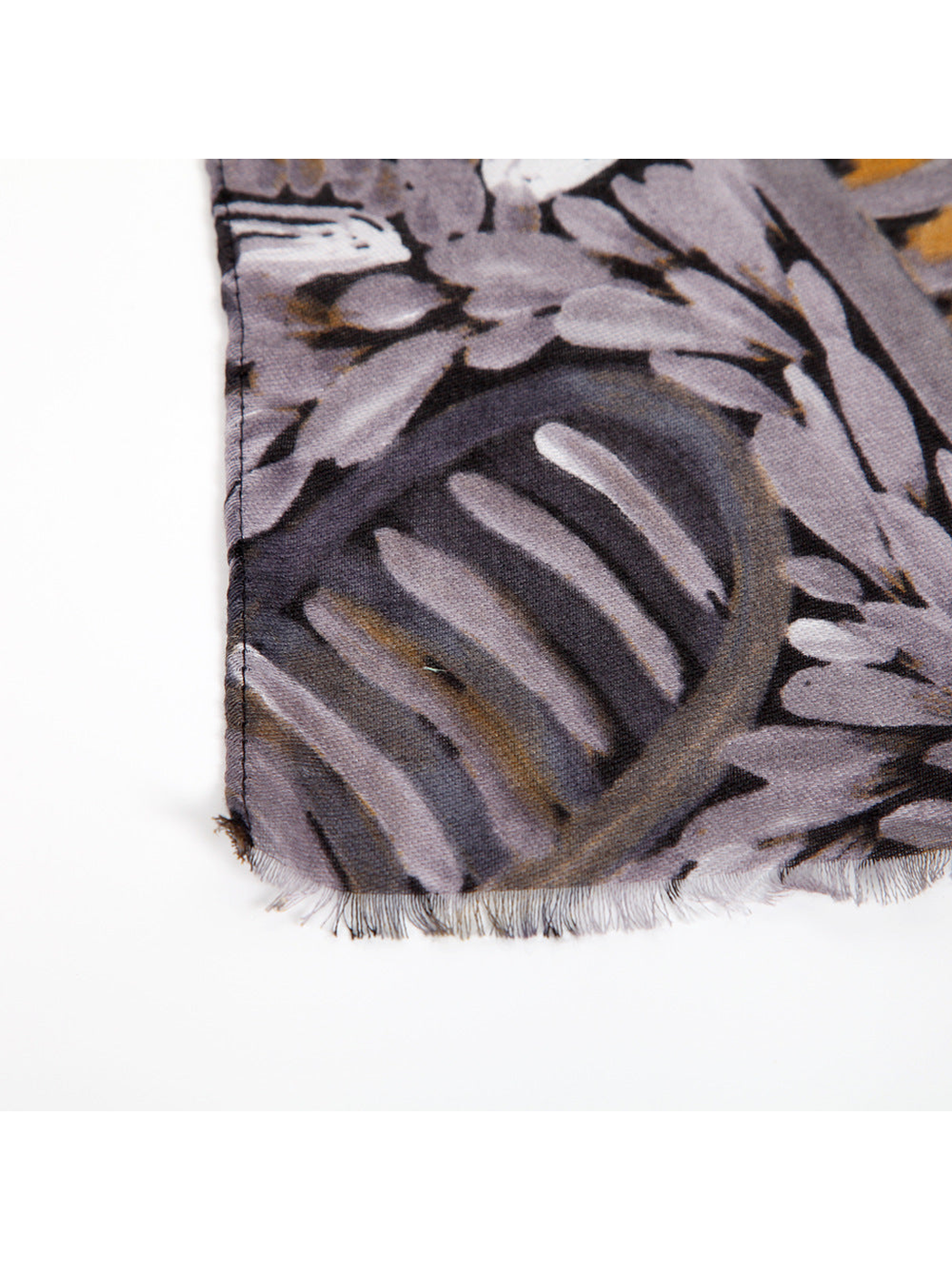 Close-up of the scarf's short fringed edge and printed surface