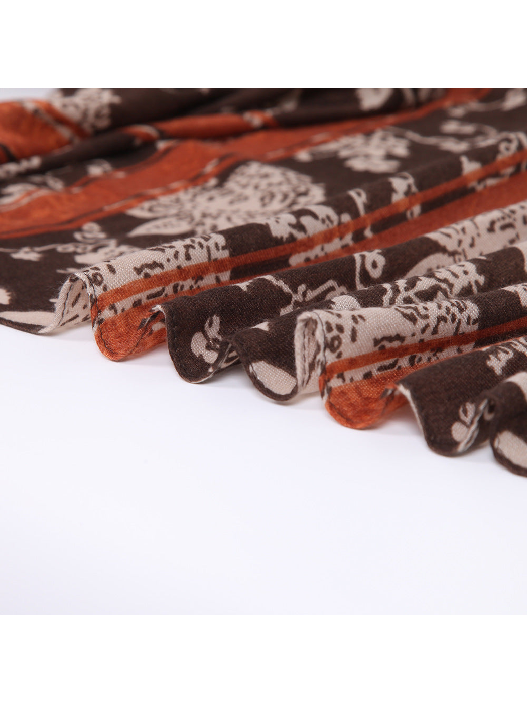 Close-up of the brown and rust scarf edge and fine woven-look texture