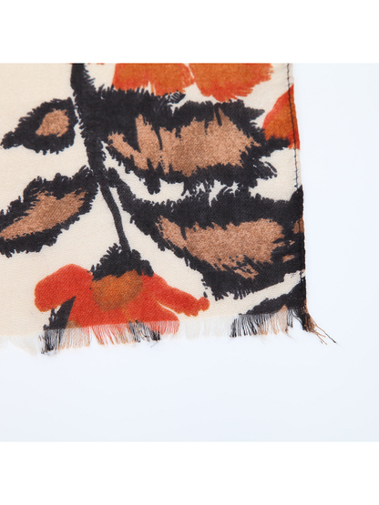 Close-up of the botanical scarf print and finely fringed edge