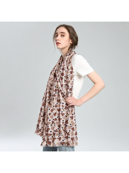 Beige heart-print scarf worn long over a white top