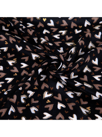 Close-up of the heart pattern and gold-tone accents on the black scarf