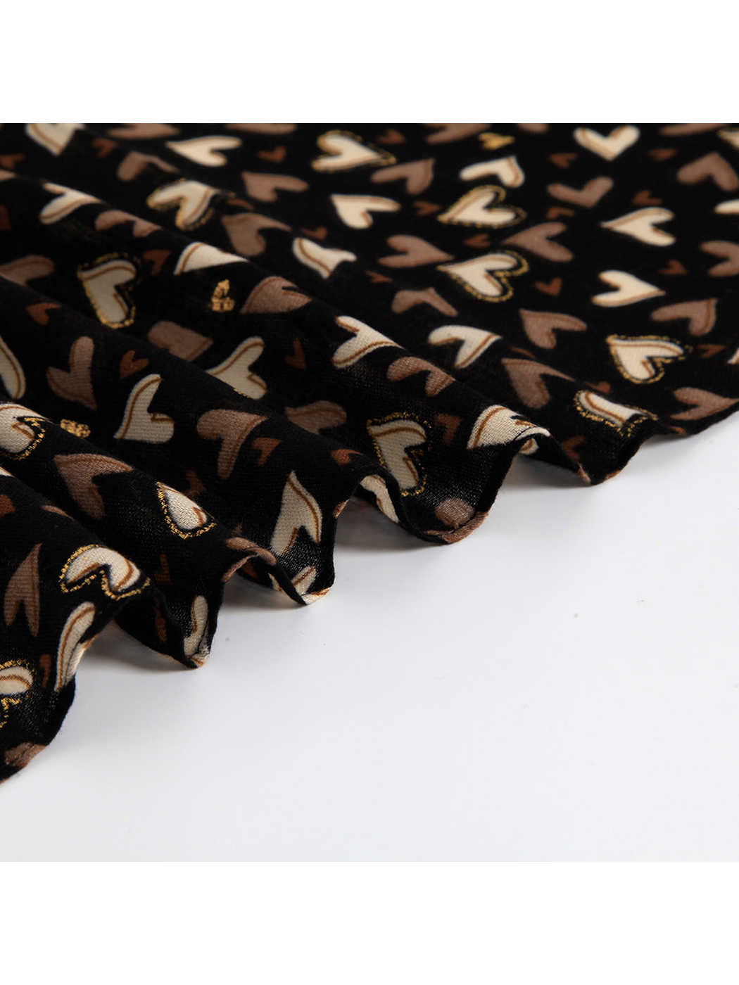Close-up of the black heart-print scarf drape and finished edge
