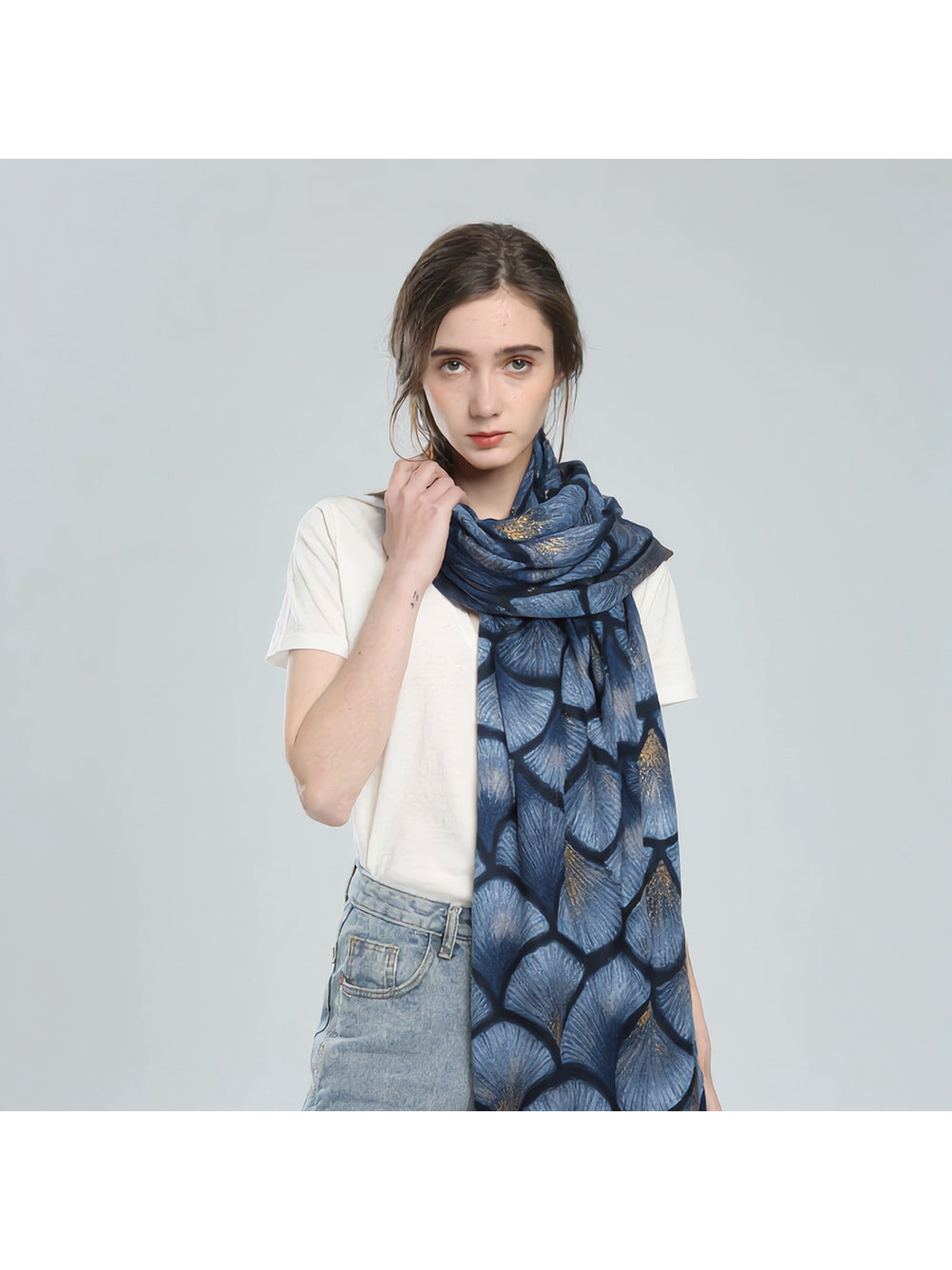 Blue ginkgo-pattern scarf styled around the neck