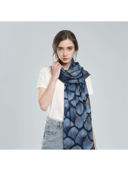 Blue ginkgo-pattern scarf styled around the neck