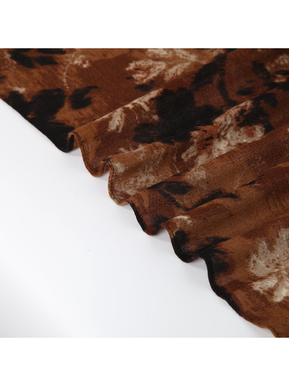 Close-up of the brown floral scarf arranged in soft folds