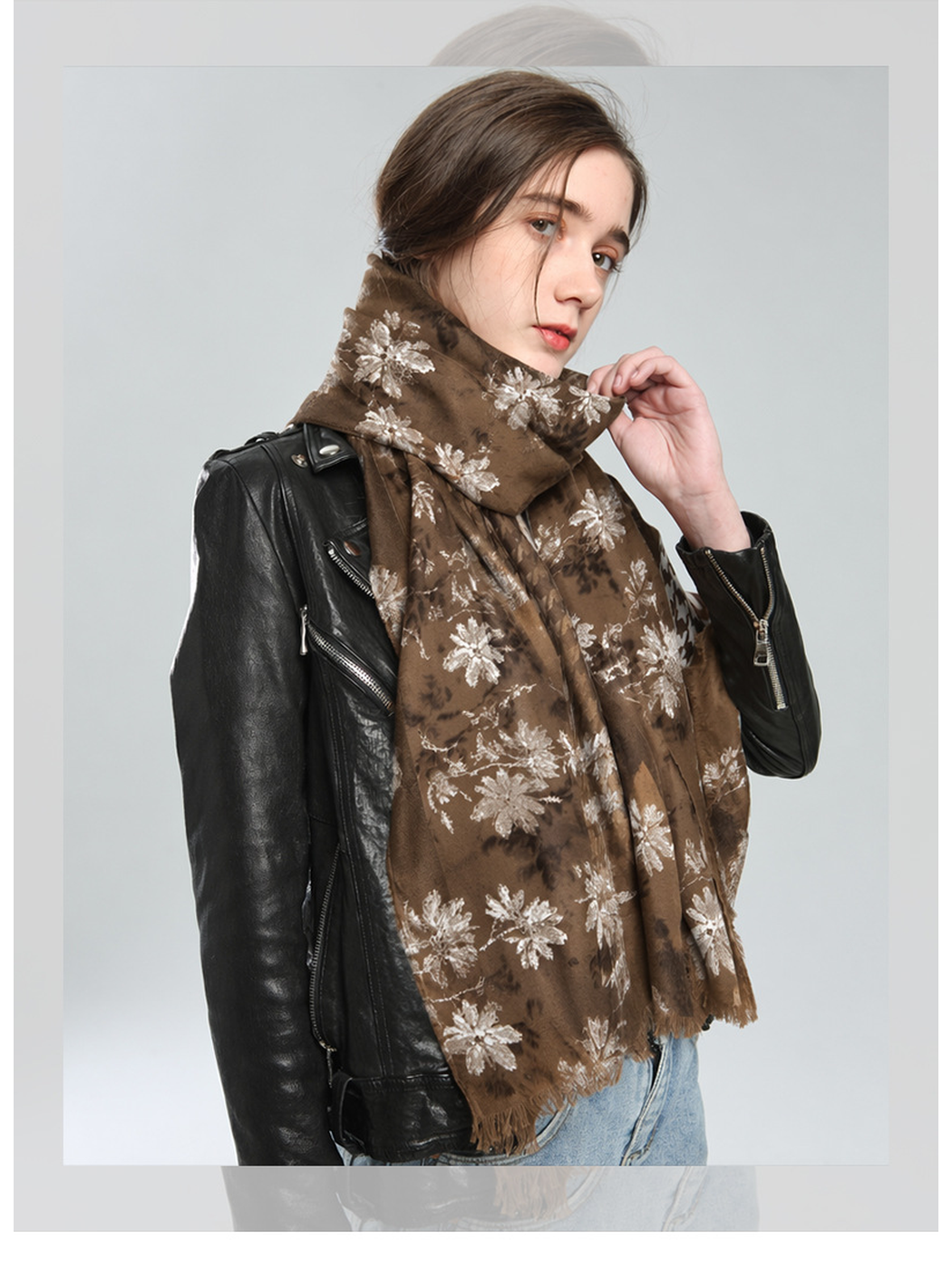 Brown floral scarf wrapped around the neck and draped over a black jacket