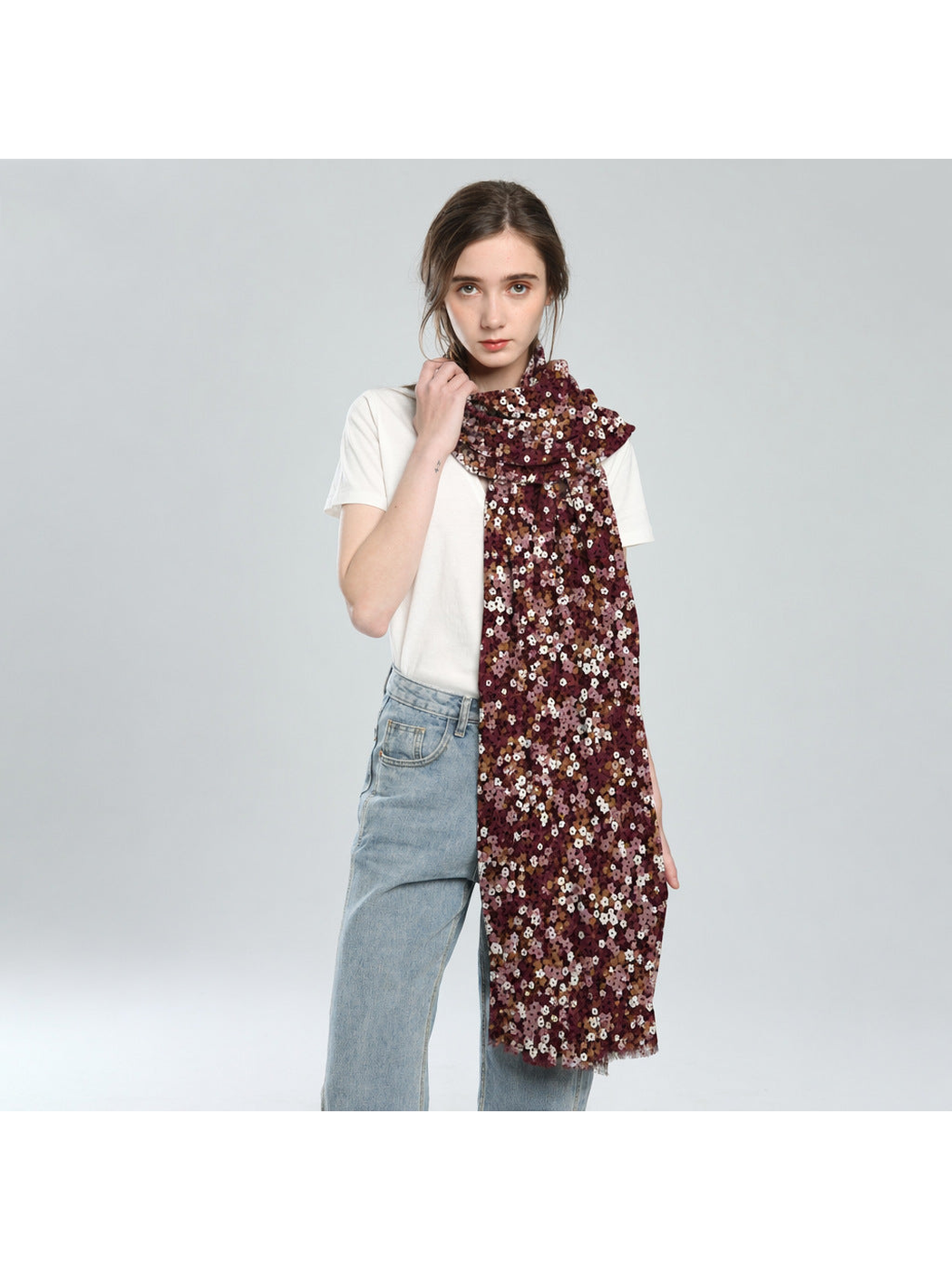 Burgundy floral scarf looped at the neck with one end hanging below the waist