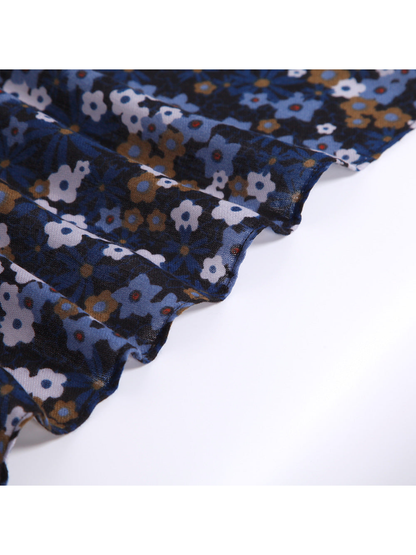 Close-up of the navy floral scarf draped in lightly sheer folds