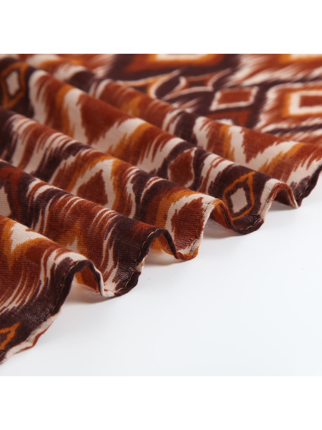 Close-up of the scarf's fine woven texture and short fringed edge