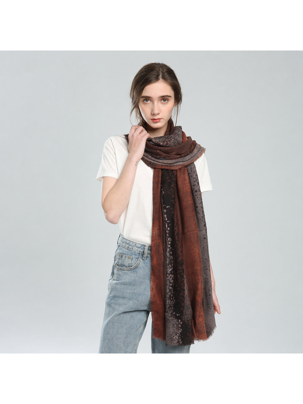 Rust and gray animal-print scarf wrapped at the neck with long draped ends