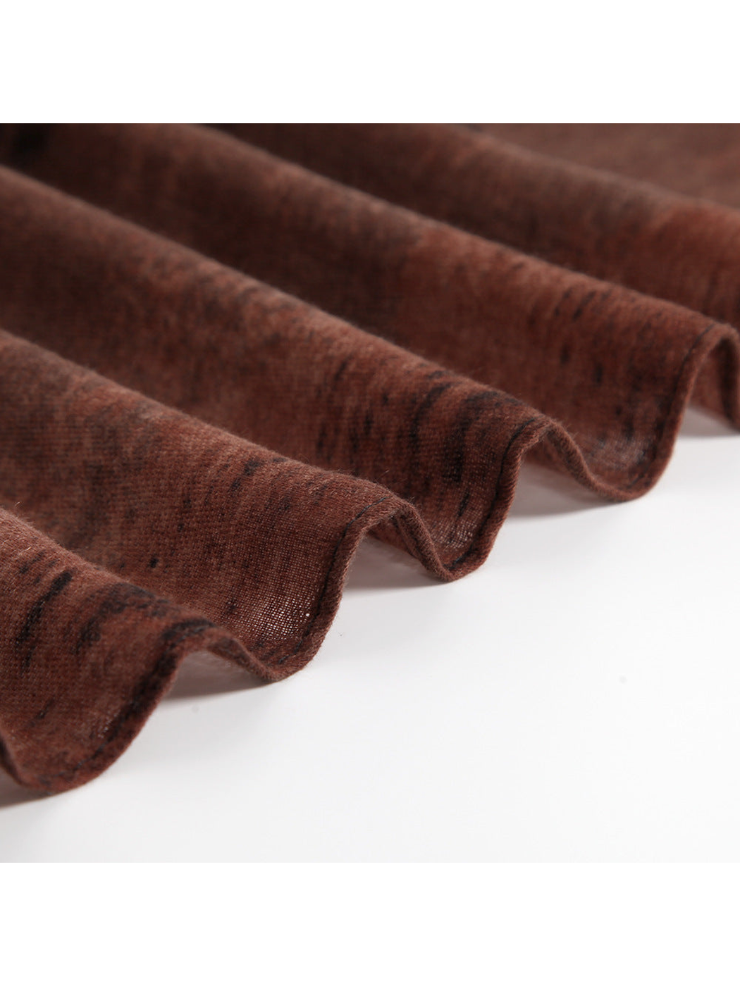 Close-up of the rust scarf's fine woven texture and lightweight drape