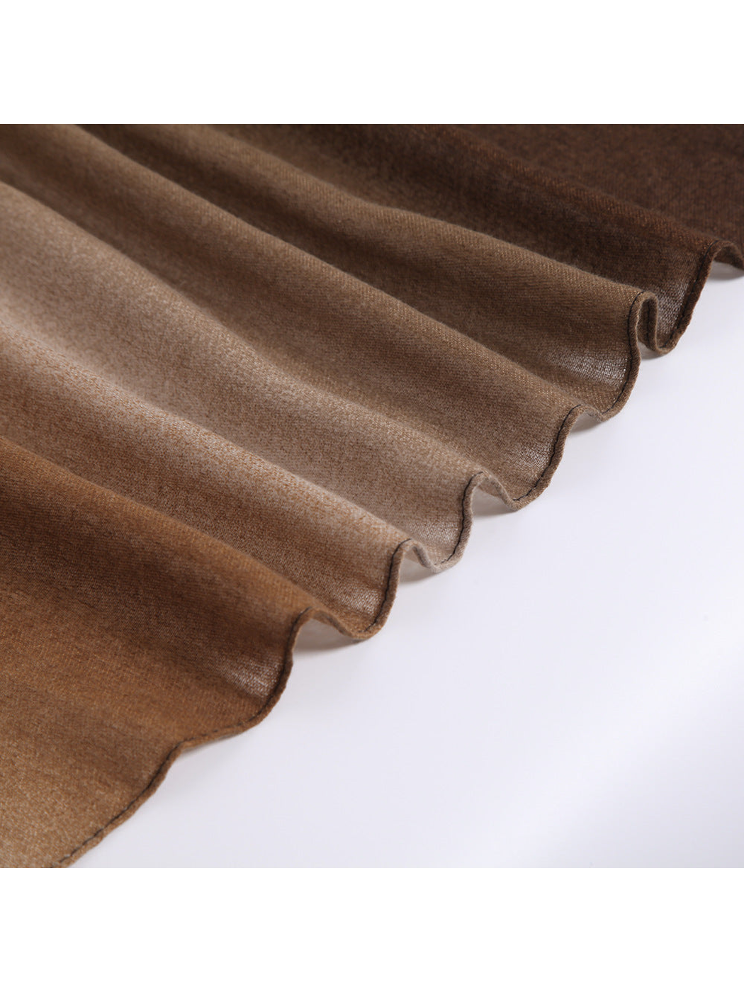 Close-up of the ombre scarf's fine woven-look texture and drape