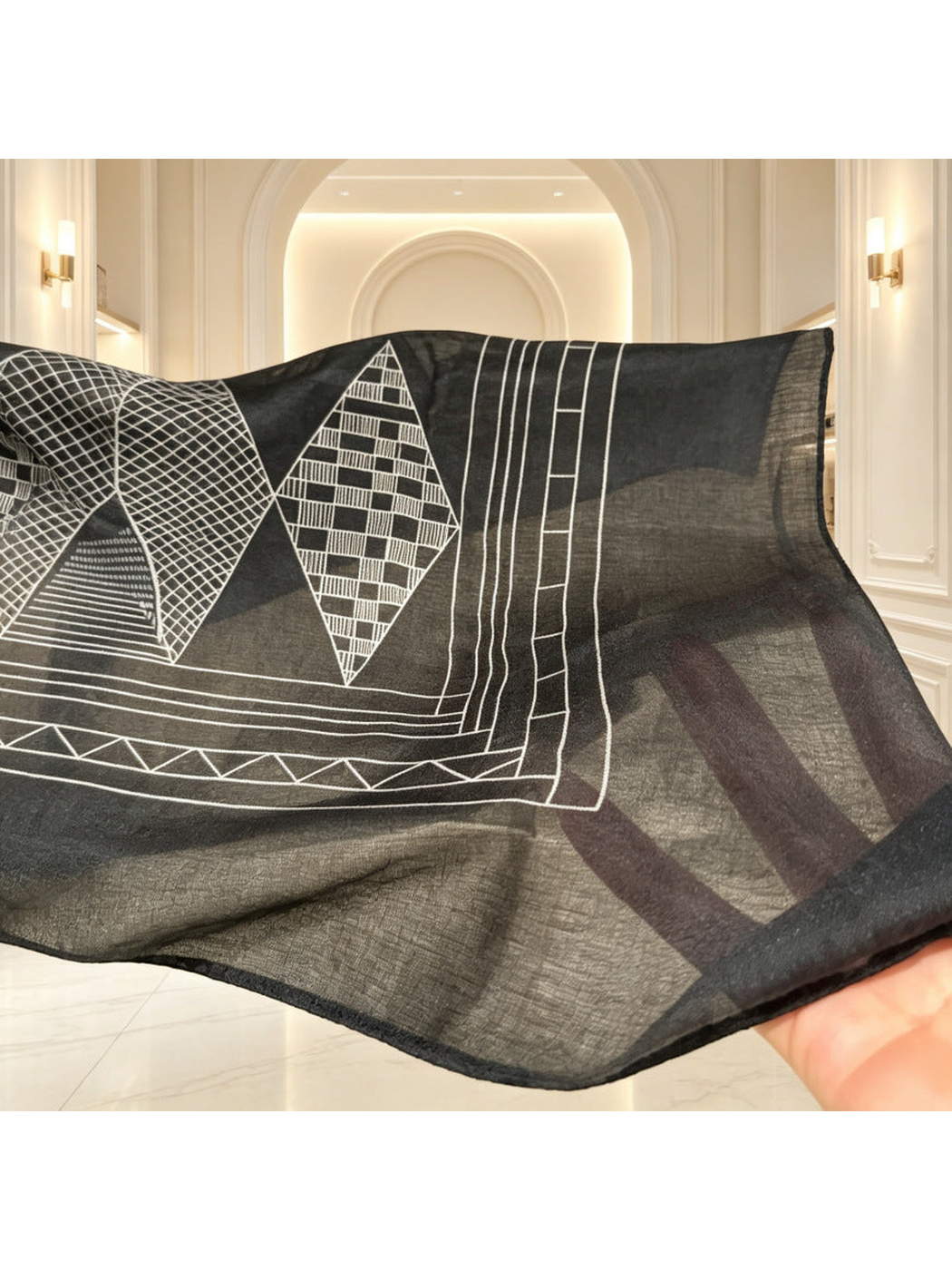 Close-up of the scarf's sheer dark border and narrow stitched edge