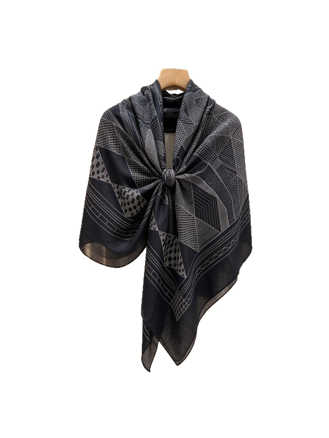 Black and gray geometric scarf tied on a hanger with pointed tails