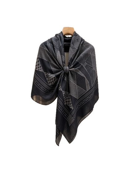 Black and gray geometric scarf tied on a hanger with pointed tails