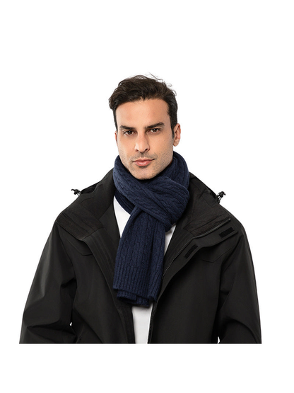 Navy cable-knit scarf worn in a front-facing looped style