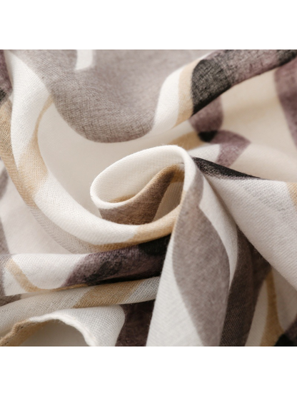 Close-up of the semi-sheer woven look and soft folds of the gray scarf