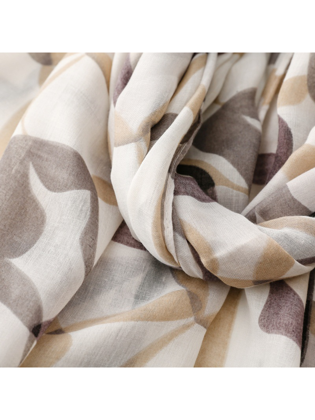 Close-up of the gray abstract-print scarf arranged in flowing folds