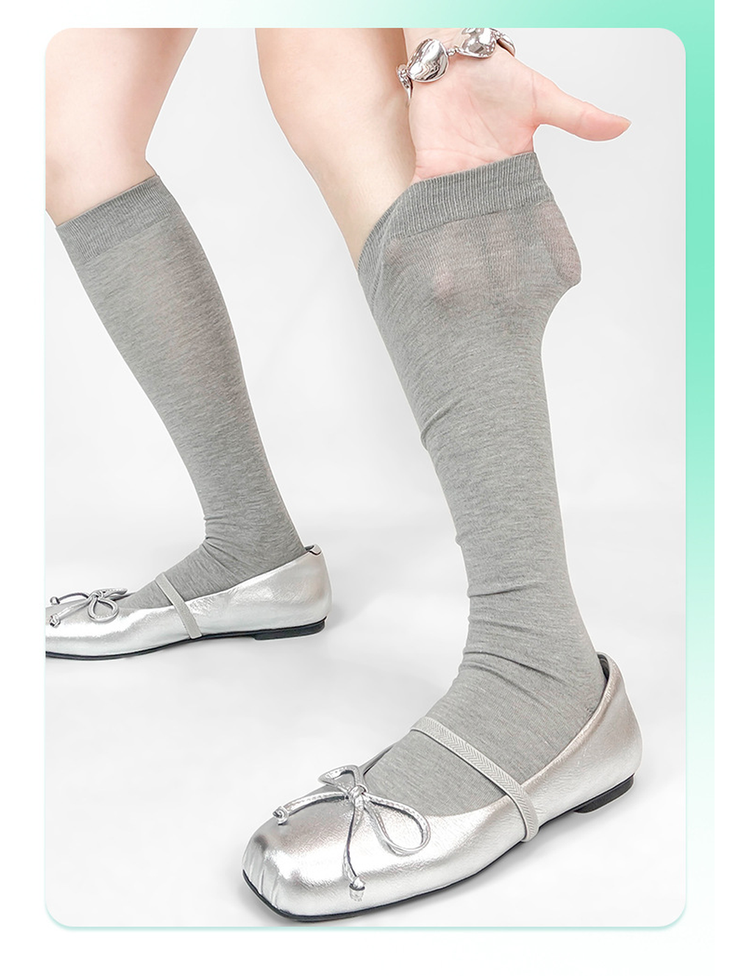 Gray knee-high socks styled with silver flats