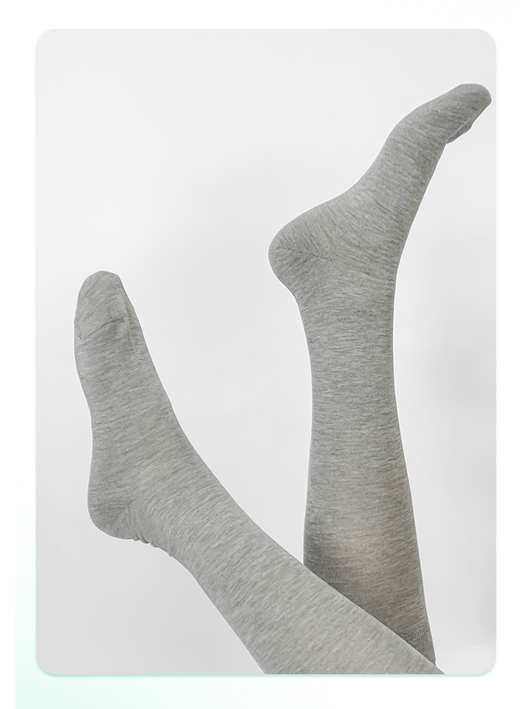 Gray knee-high socks displayed with crossed legs