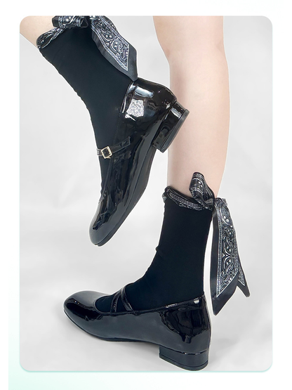 Black ribbon-bow crew socks styled with black shoes
