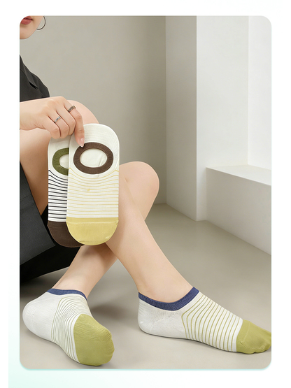 Yellow and green striped no-show socks worn with two color options held above