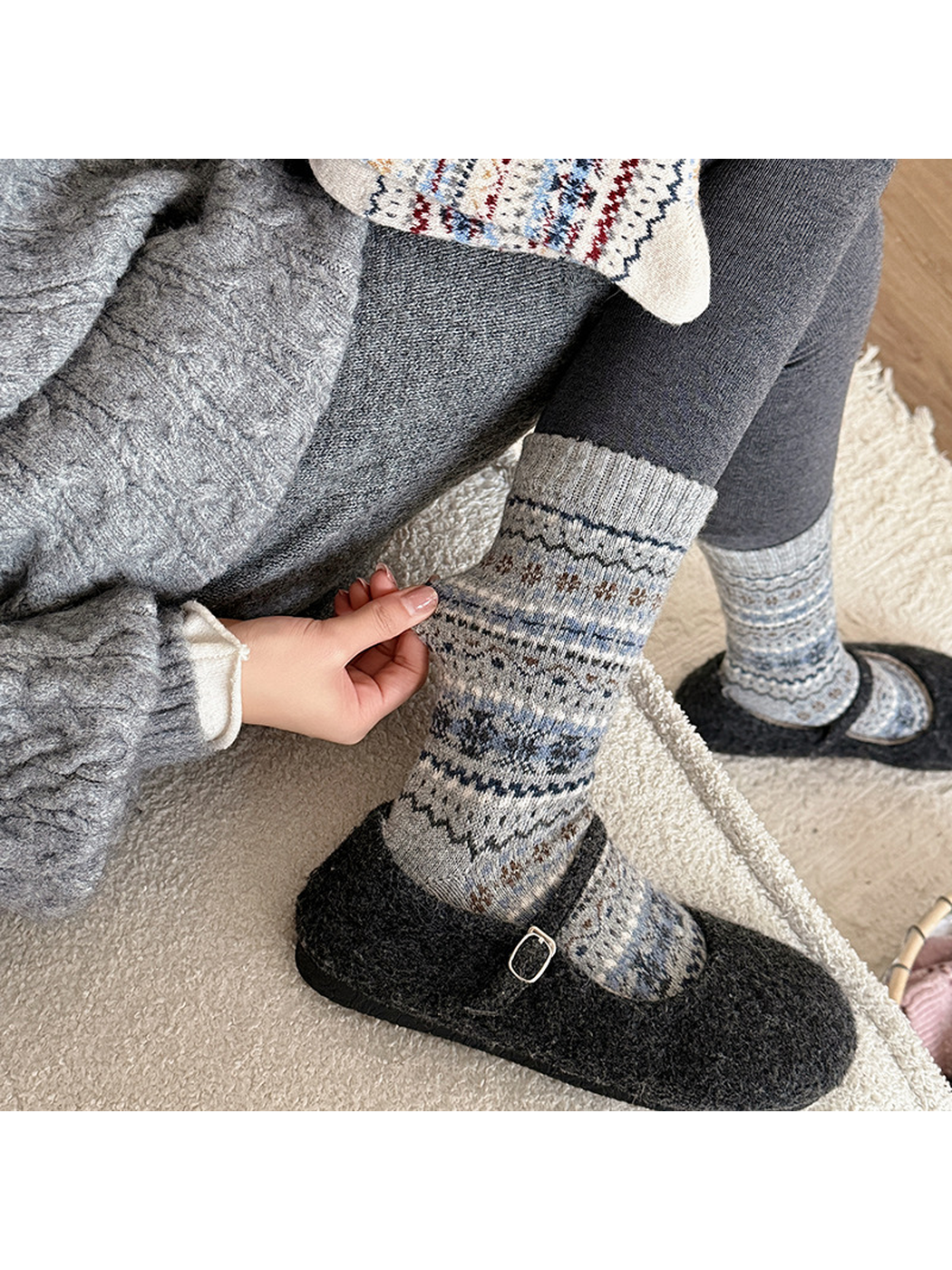 Gray patterned crew socks styled with black slip-on shoes