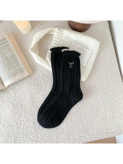 Black cable-knit crew socks with contrast bow embroidery