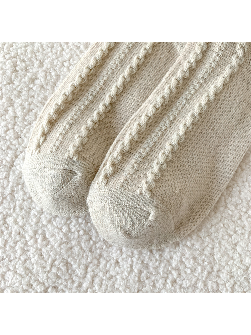Close-up of the cable-knit columns and shaped toe seams
