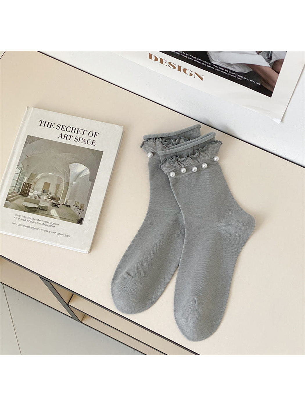 Light gray ruffled crew socks with white bead-like cuff accents