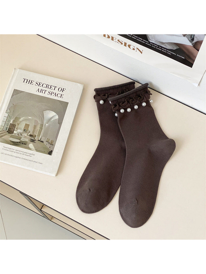 Dark brown ruffled crew socks with white bead-like cuff accents